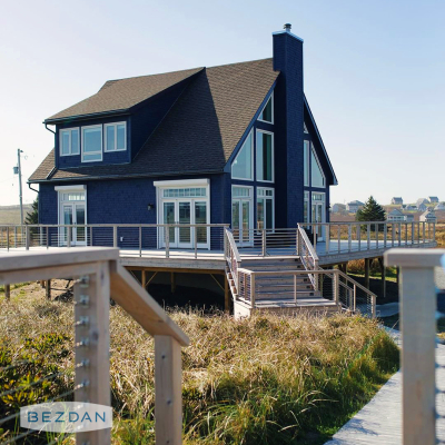 Coastal deck cable railing with CR1630 surface mount tensioner, CR1635 non-tensioner, and CR1600 cable.
