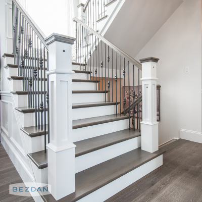 Staircase with TimeLine TL230-1RD and TL230-2RD steel balusters featuring white newel posts and dark wood steps.