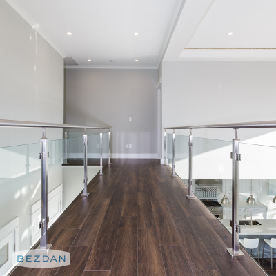 Glass railing with square posts 9421, glass clips S7340SB-B, and round tube 9010 installed along a loft walkway.