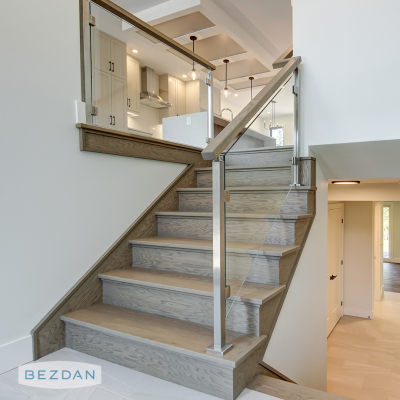 Glass stair railing with stainless square posts 9450, glass clips 97305SB-B, and top mount brackets 9602.