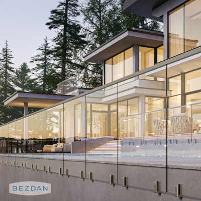 Frameless glass railing with stainless fascia mount spigots 8040 and square cap rail 9480 on a modern terrace.