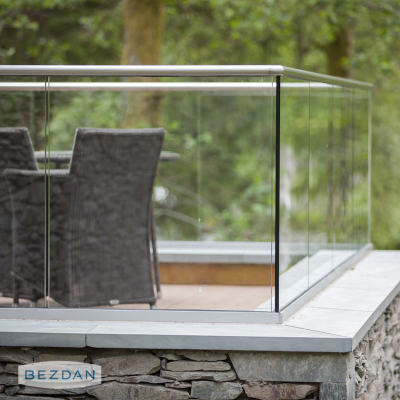 Frameless glass railing with stainless top mount base shoe 16.6904.300.18 on a covered deck.