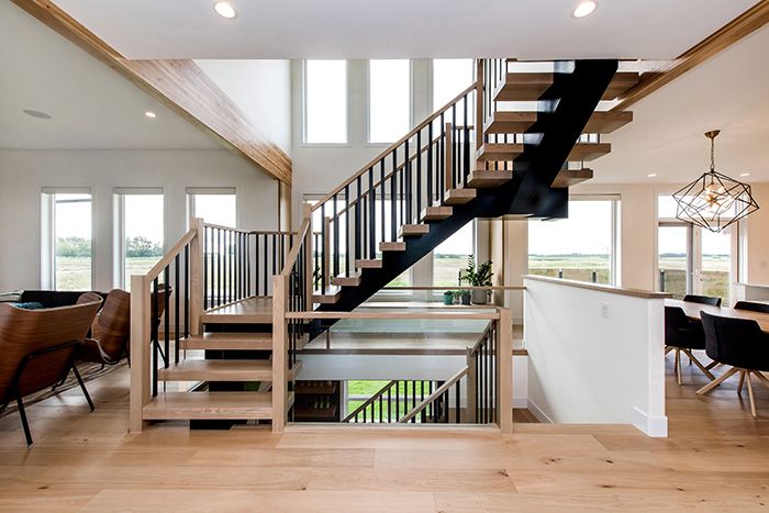 Photo Source: Bezdan Sales The thick rectangular spindles make a bold impact, and using just two per tread keeps everything up to code