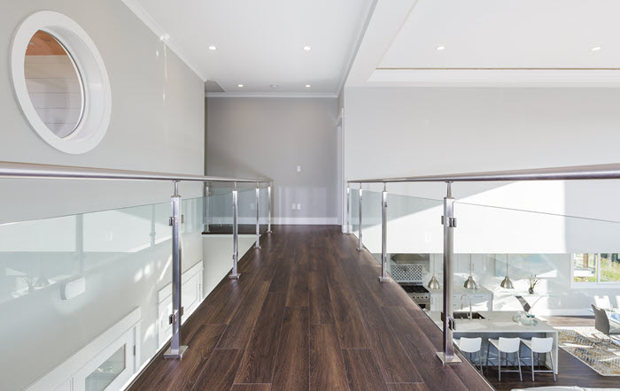 glass walkway with square posts and round handrail in satin finish